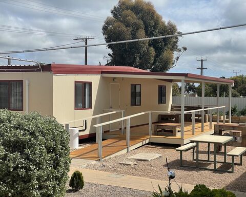 Beige colour building with sitting area and ramp