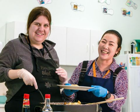 A client and support worker cooking