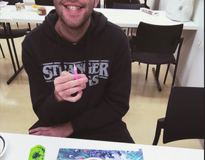 Man wearing specs smiling at camera