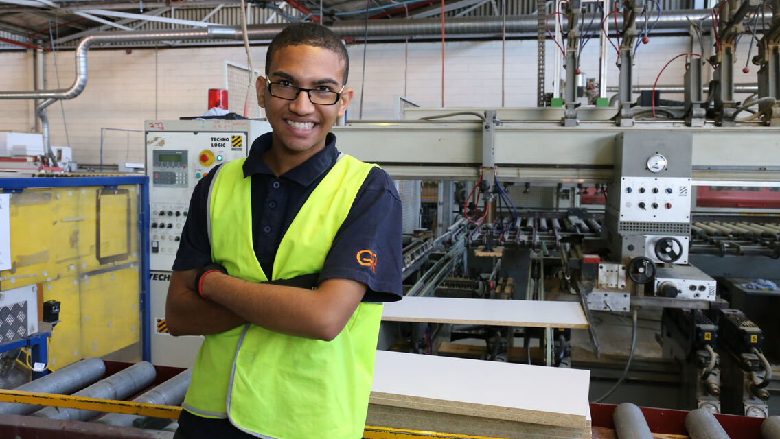 Man wearing hi-vis vests standing in factory