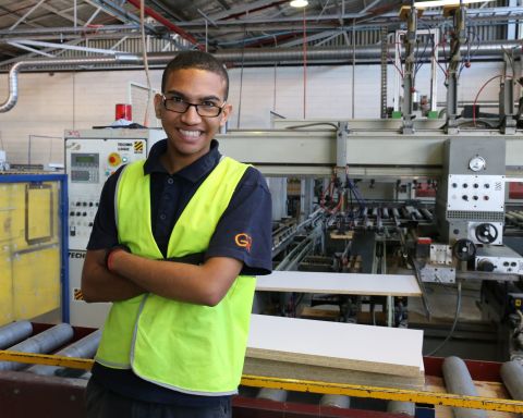 Man wearing hi-vis vests standing in factory
