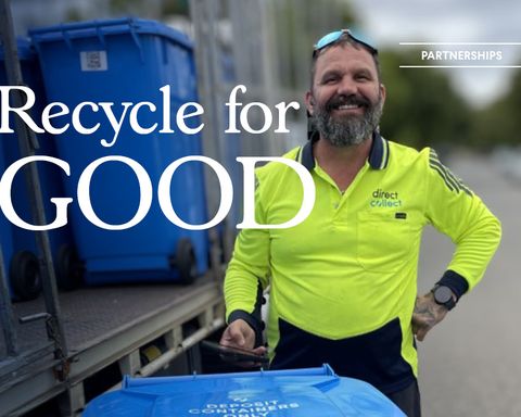 Man wearing hi-vis clothing standing next to blue colour direct collect bins