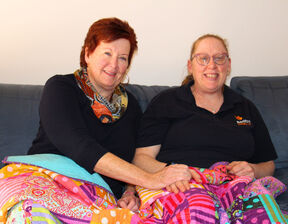 Two women sitting next to each other