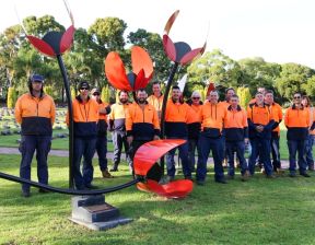 Group of people standing together wearing hi-vis orange vests
