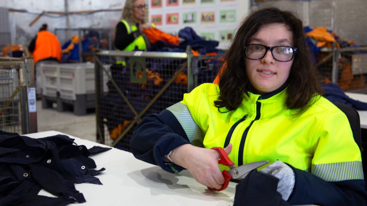 Women wearing hi-vis clothing with red colour scissors