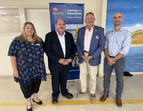 Four individuals standing next to each other