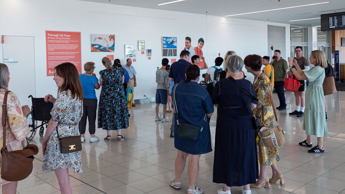 Group of people standing in groups chatting