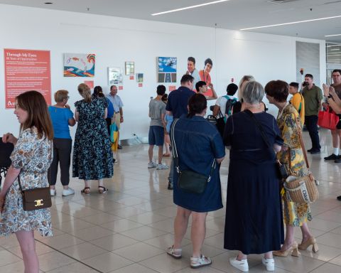 Group of people standing in groups chatting