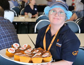 Women holding a plate of cupcakes