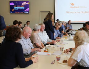 Group of people sitting and talking to each other
