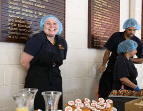 Women wearing hair net and smiling at camera