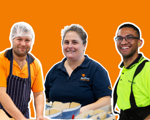 Orange background with three individuals smiling