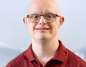 Man with specs wearing red colour polo on the cover of the book