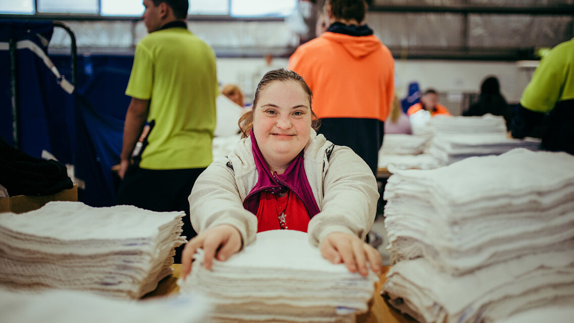 Women wearing white jacket with hands on white clothing