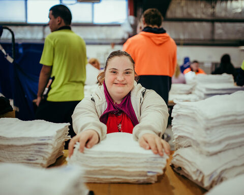 Women wearing white jacket with hands on white clothing