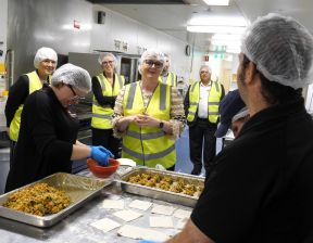 Group of people cooking wearing hair nets