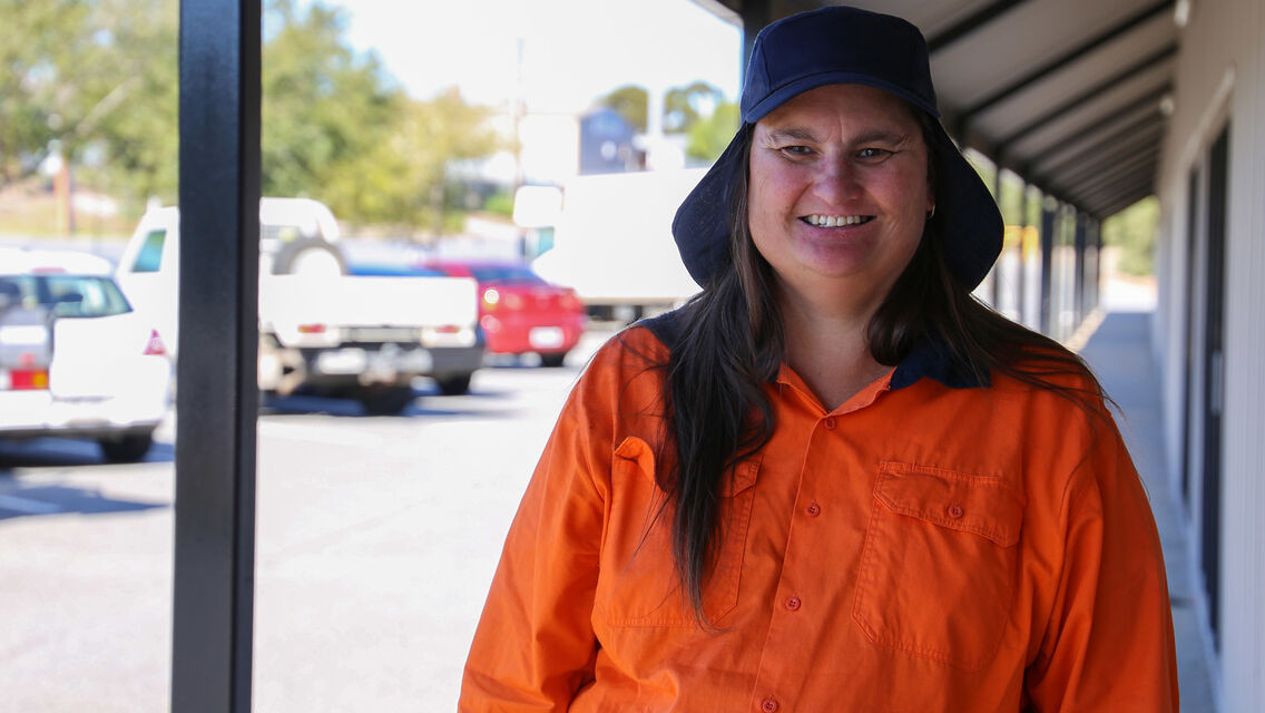 Women wearing orange clothing and dark blue bucket hat