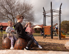 Children sitting in playground
