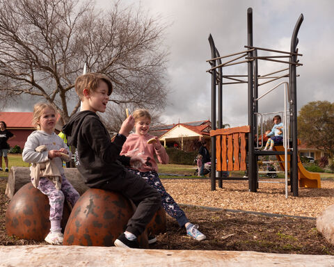Children sitting in playground