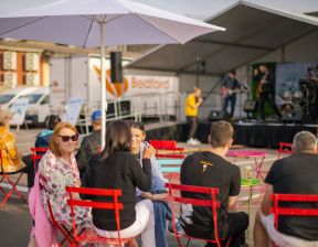 Group of individuals sitting together on red chairs