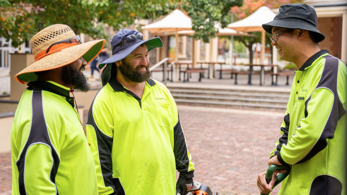 GreenInc employees talking to each other