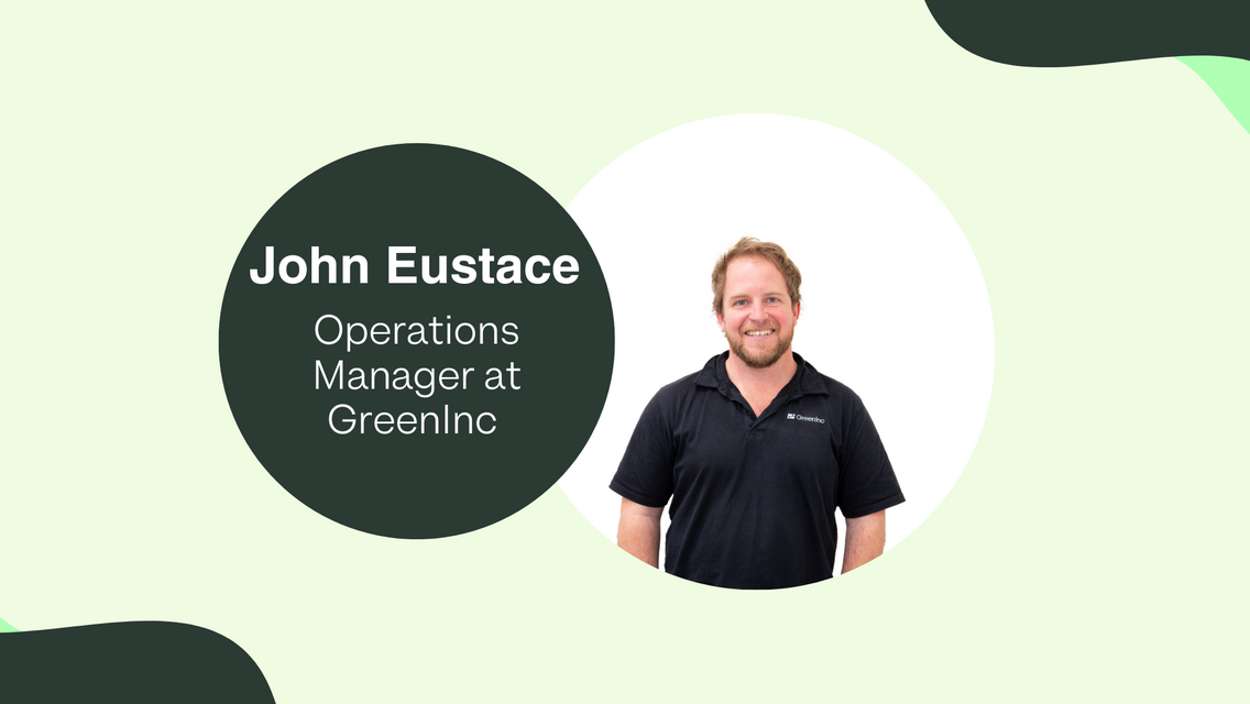 Man wearing GreenInc polo smiling with light green background