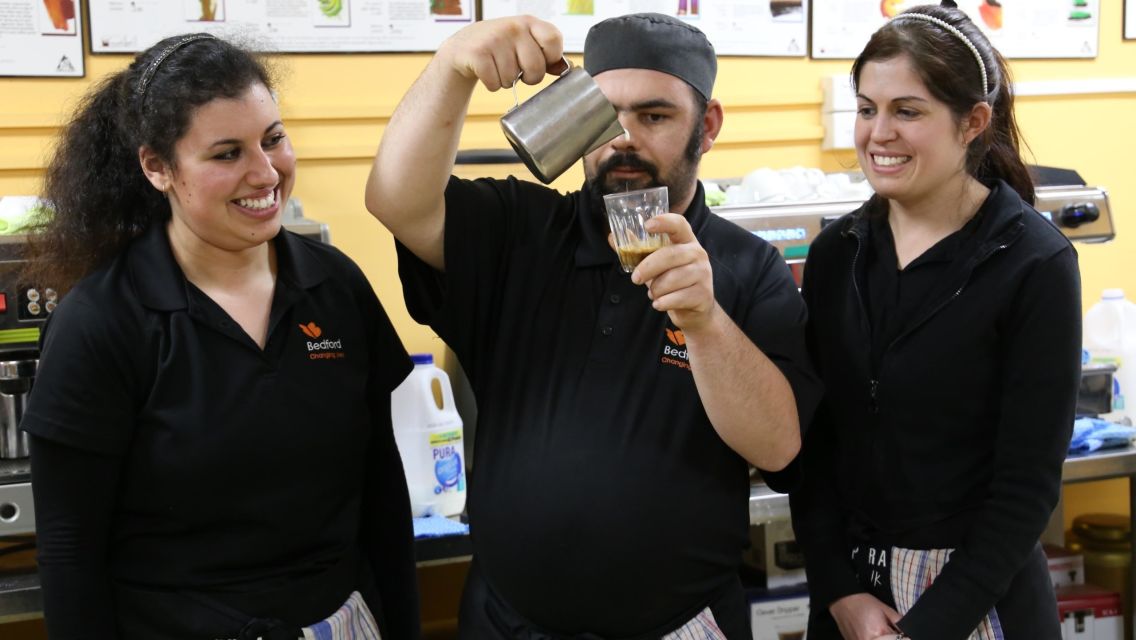Bedford Hospitality employees practice coffee-making skills.