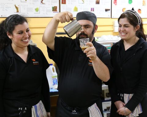 Bedford Hospitality employees practice coffee-making skills.