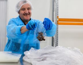 Bedford employee Paul holds a package of chocolates