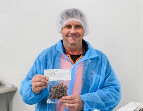 A Bedford employee holds a packet of apricot and almond clusters