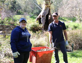 One man and women holding holding red colour basket