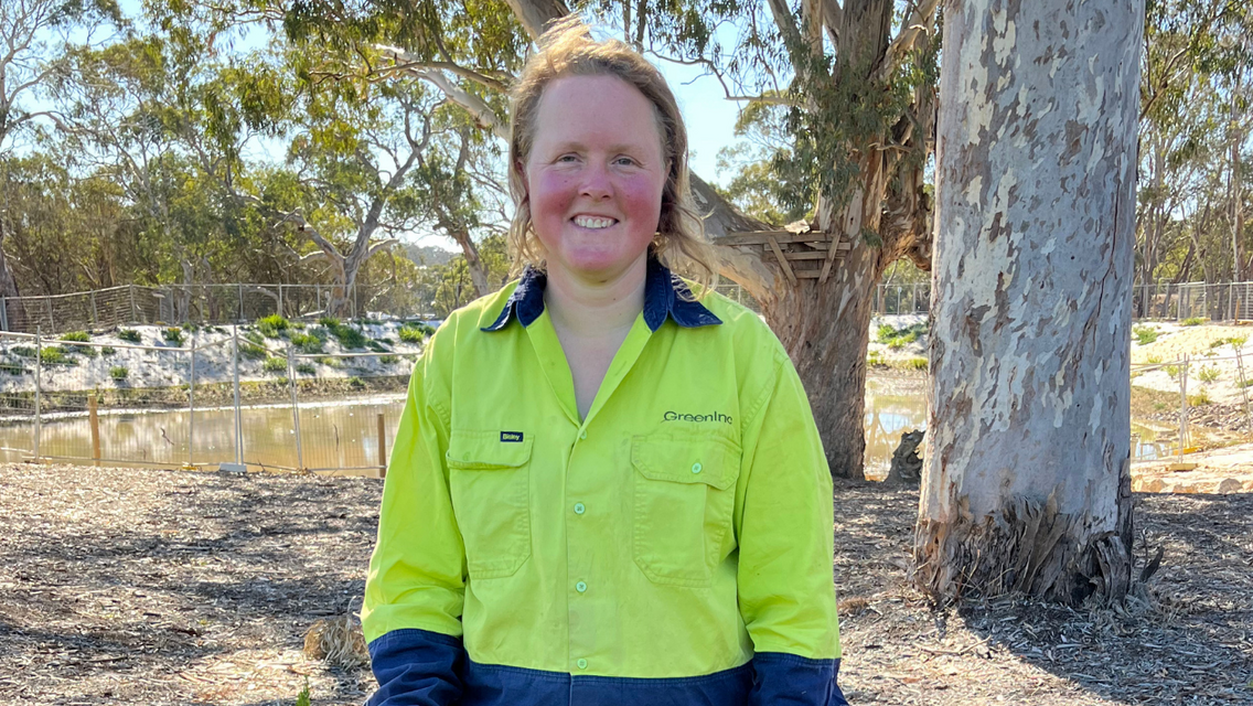 Women wearing hi-vis clothing and smiling at camera