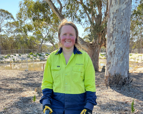 Women wearing hi-vis clothing and smiling at camera