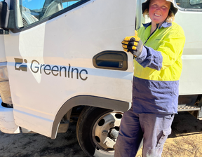 Women holding GreenInc truck door