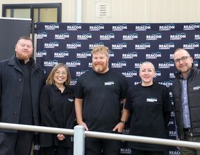 Group of individuals smiling for a picture