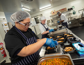Women wearing apron preparing food