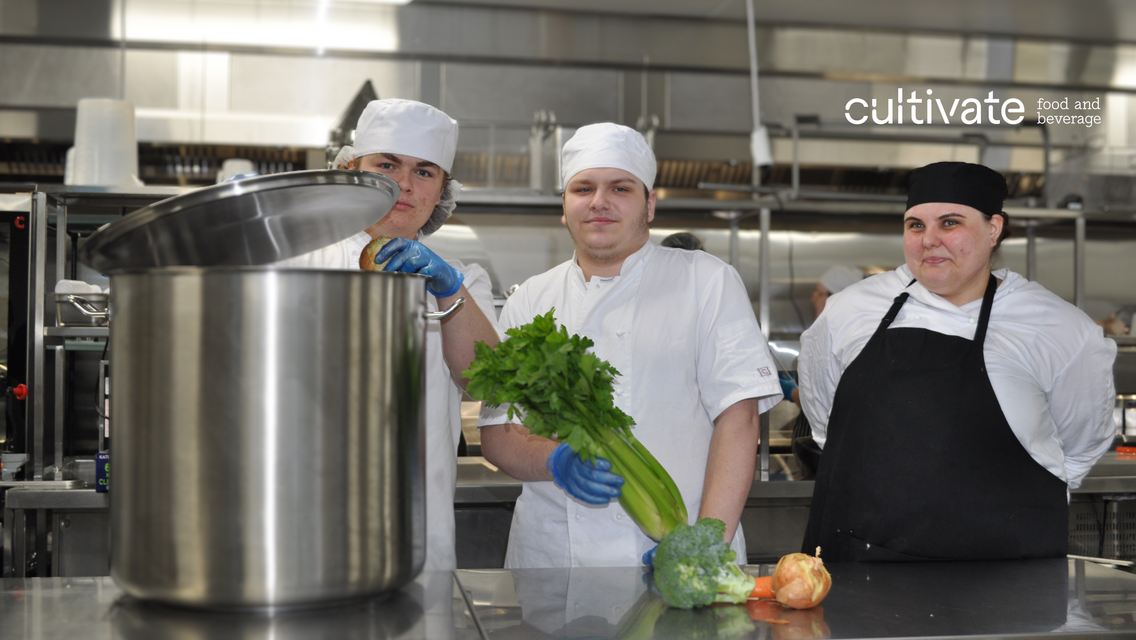 3 chefs with black aprons smiling