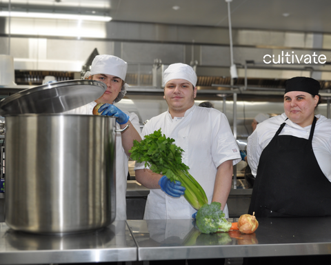 3 chefs with black aprons smiling
