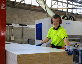 Man wearing neon clothing with protective eye wear smiling at camera