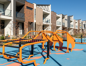 Orange colour play equipment with buildings behind