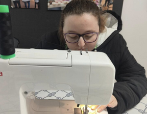 Women using white colour sewing machine