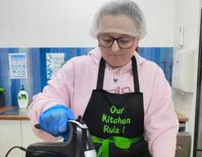 Women wearing black colour apron and hair net whisking