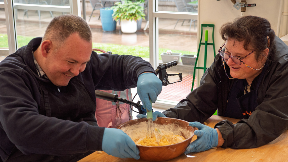 Man and women mixing up cake batter
