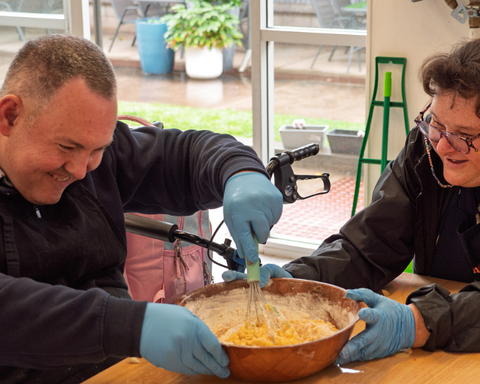Man and women mixing up cake batter